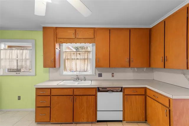 a kitchen with stainless steel appliances sink cabinets and a window