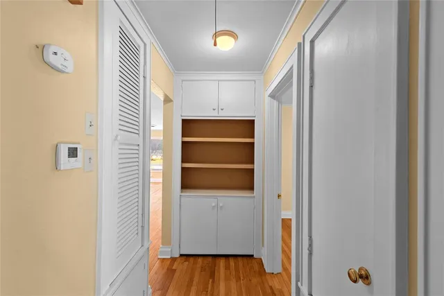 a view of walk in closet with empty racks