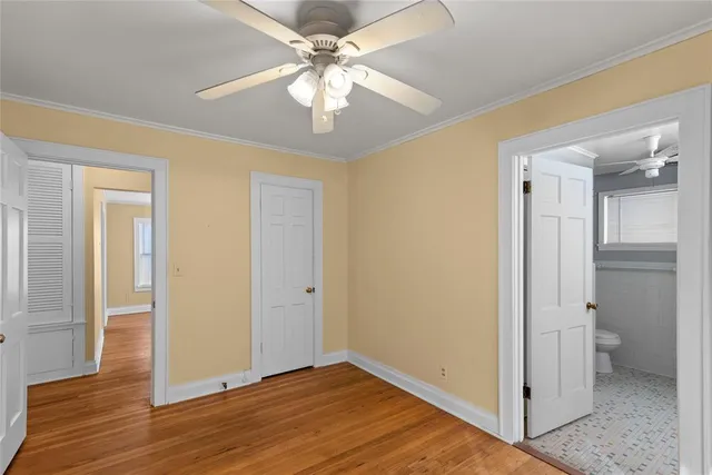 wooden floor in an empty room with a bathroom