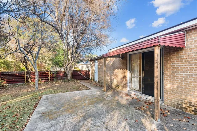 a view of a house with a outdoor space and tree s