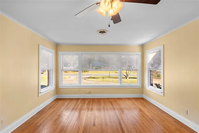 wooden floor in an empty room with a window