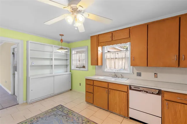 a kitchen with a sink cabinets and window