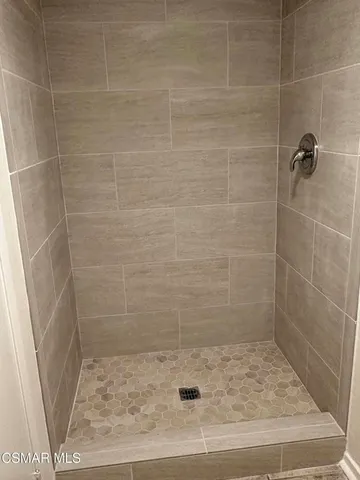 a bathroom with a granite countertop sink and a toilet