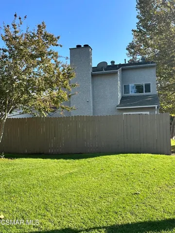 a view of yard with swimming pool and green space