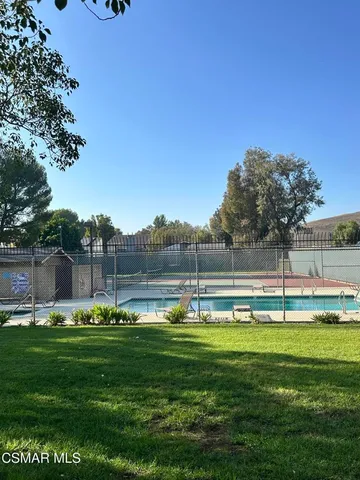 a view of swimming pool and trees in the background