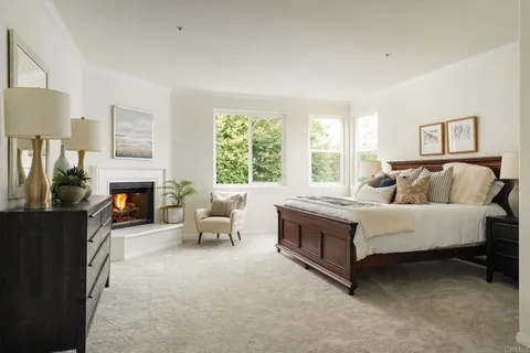 a spacious bedroom with a bed and a fireplace
