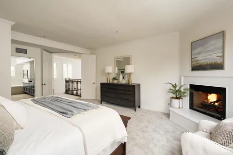 a bedroom with a bed and a fireplace
