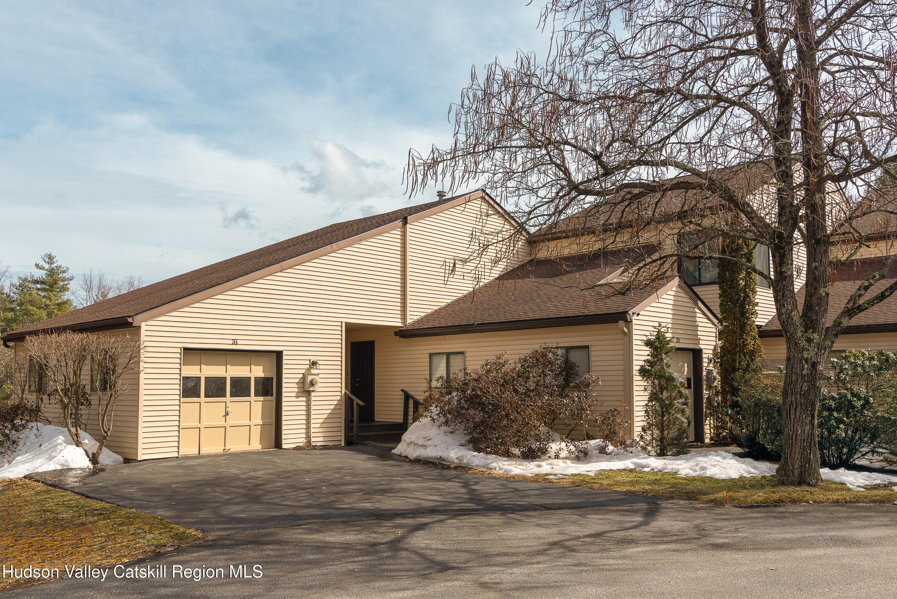 31 Pond Park Road Hurley, NY 12498 - Photo 1 of 39 a front view of a house with a yard and garage