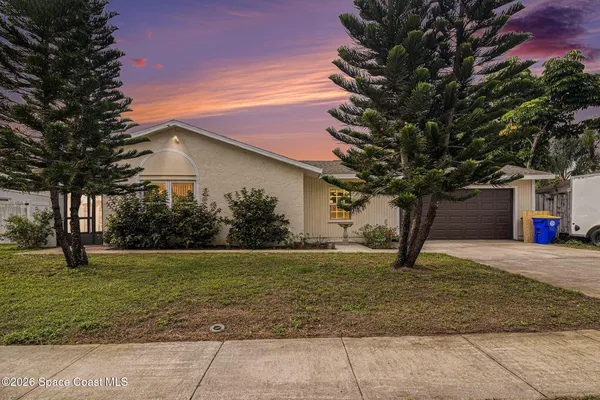 a house that has a tree in front of it