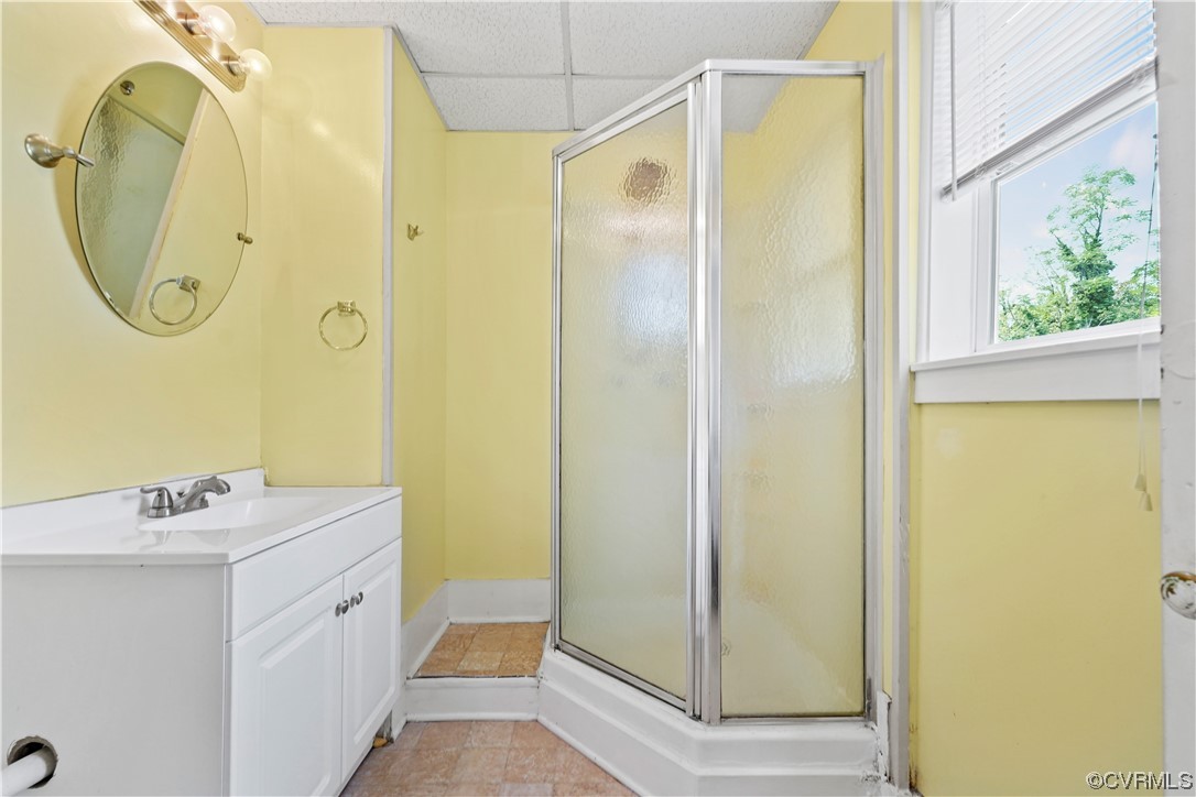 3620 Benton Avenue Richmond, VA 23222 - Photo 12 of 23 a bathroom with a sink a mirror a shower and a window