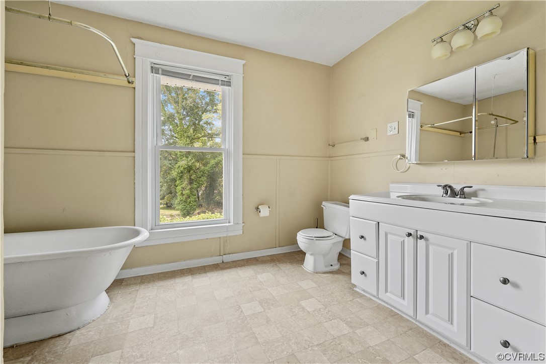 3620 Benton Avenue Richmond, VA 23222 - Photo 16 of 23 a bathroom with a granite countertop toilet a sink and a mirror