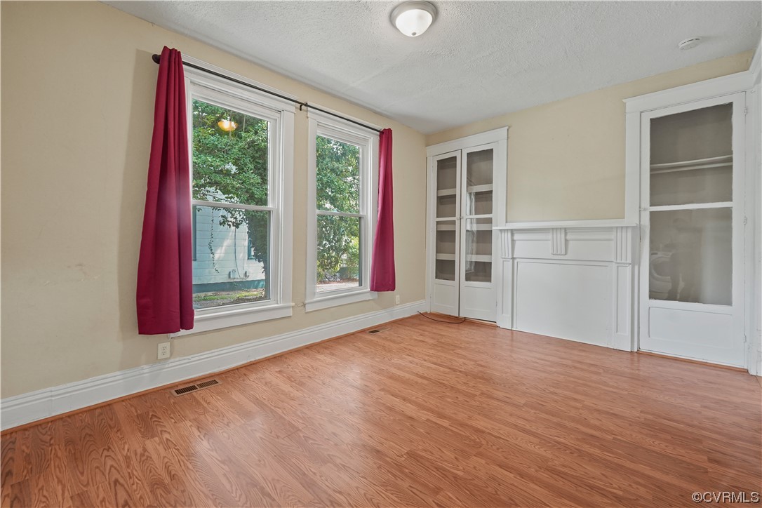 3620 Benton Avenue Richmond, VA 23222 - Photo 5 of 23 a view of an empty room with wooden floor and a window