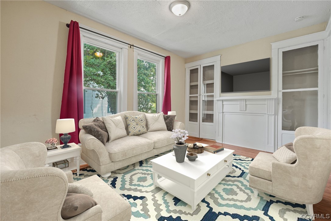 3620 Benton Avenue Richmond, VA 23222 - Photo 6 of 23 a living room with furniture a flat screen tv and a large window