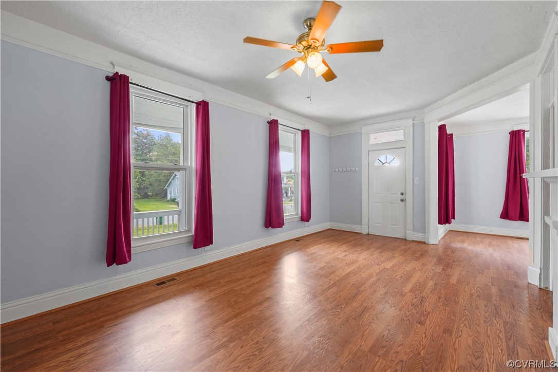 3620 Benton Avenue Richmond, VA 23222 - Photo 7 of 23 a view of an empty room with window a ceiling fan and wooden floor