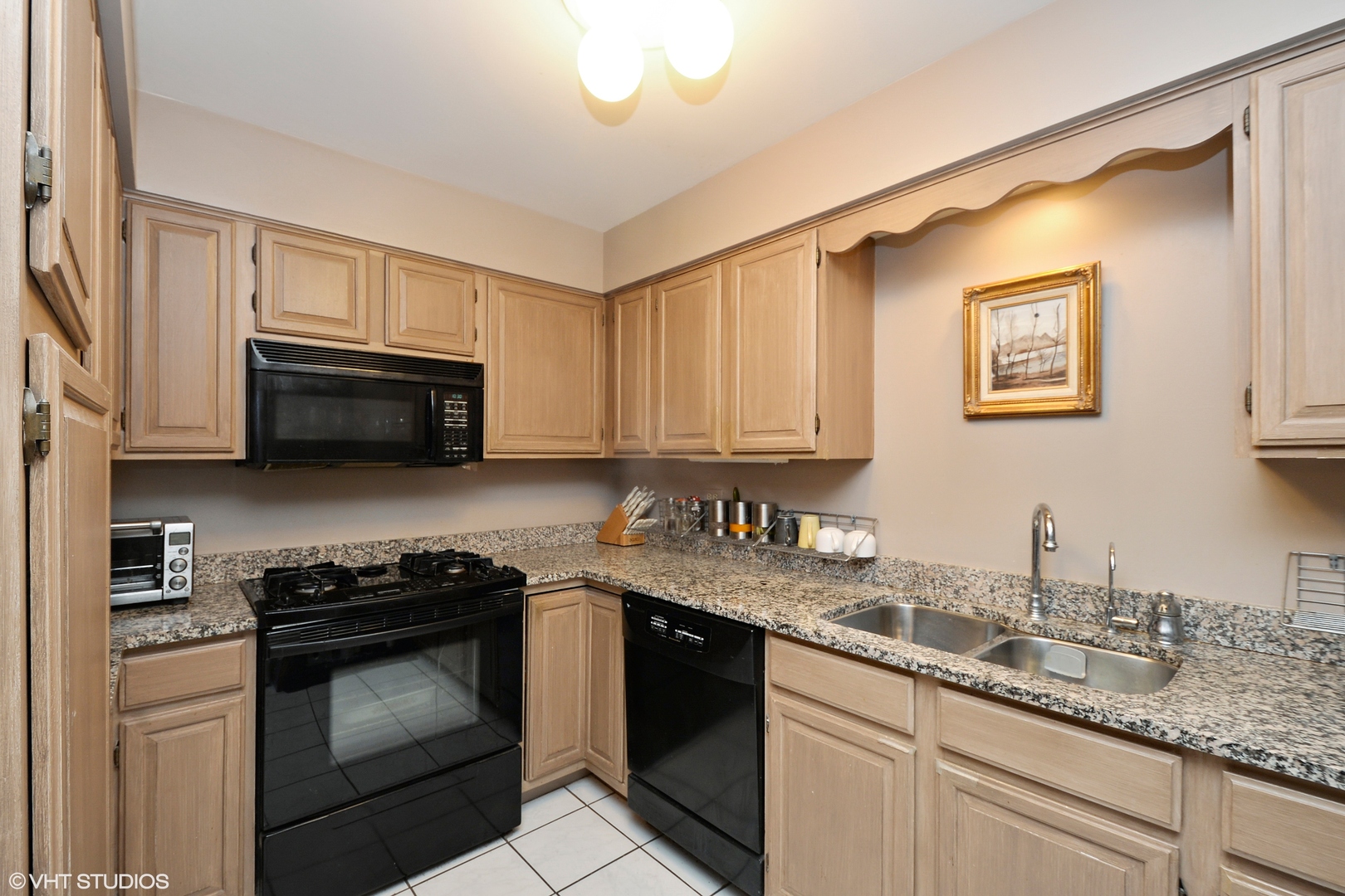 702 South Lytle Street, Unit 2N Chicago, IL 60607 - Photo 17 of 23 a kitchen with granite countertop cabinets stainless steel appliances and a sink