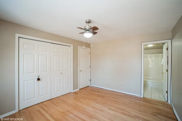 a view of a room with a ceiling fan and closet