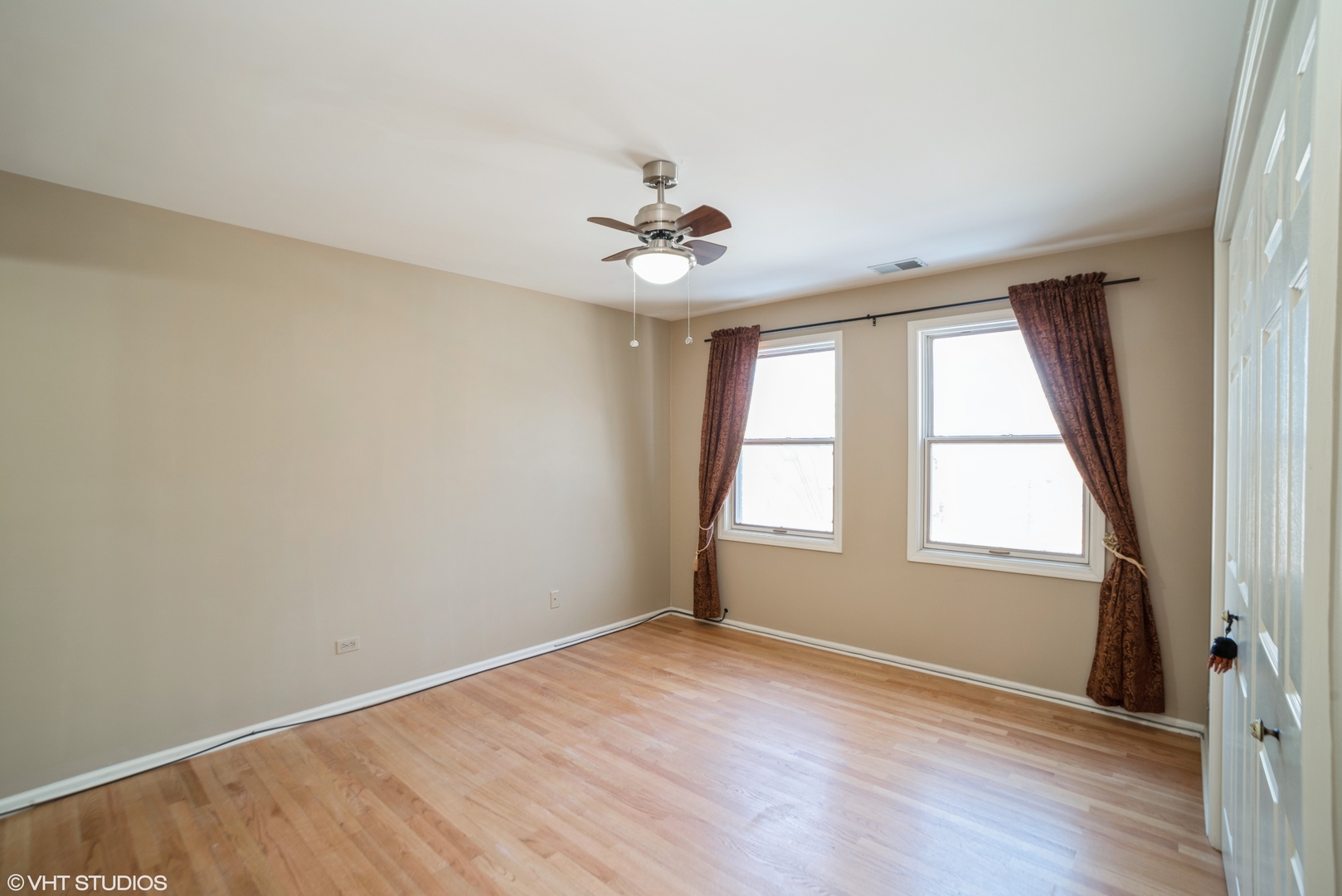 702 South Lytle Street, Unit 2N Chicago, IL 60607 - Photo 7 of 23 an empty room with wooden floor and windows