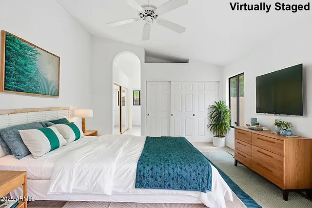 a bedroom with a bed and a flat screen tv