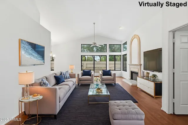 a living room with furniture fireplace and flat screen tv