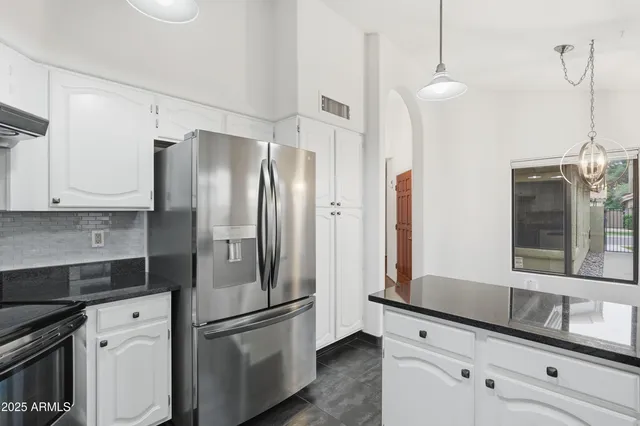 a kitchen with stainless steel appliances a refrigerator sink and microwave