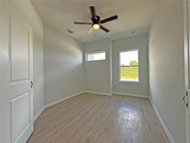 wooden floor in an empty room with a window