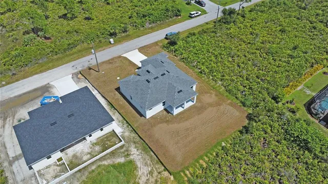 an aerial view of a house with a yard