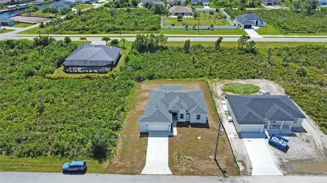 an aerial view of a house with a yard