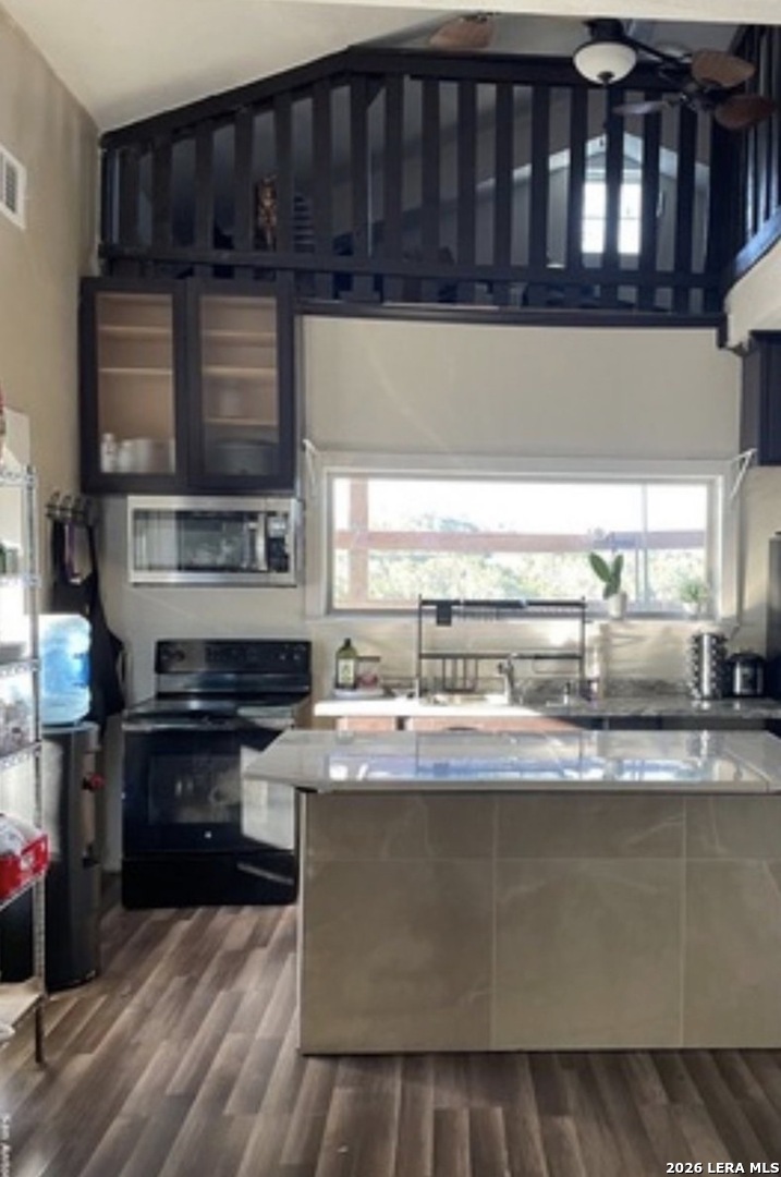 272 Plum Cove Road Lakehills, TX 78063 - Photo 3 of 11 a kitchen with stainless steel appliances granite countertop a stove a sink and a microwave
