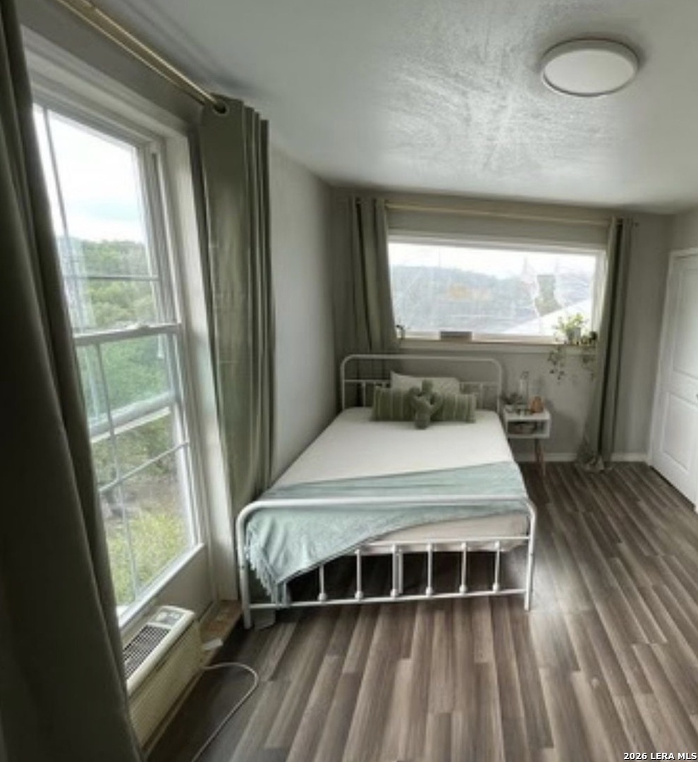 272 Plum Cove Road Lakehills, TX 78063 - Photo 6 of 11 a bedroom with a bed and large window