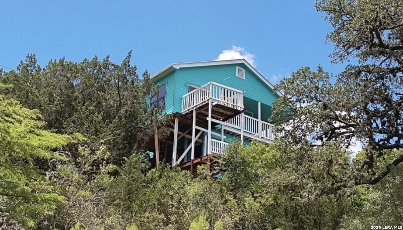 272 Plum Cove Road Lakehills, TX 78063 - Photo 9 of 11 an aerial view of a house with a yard and trees in the background