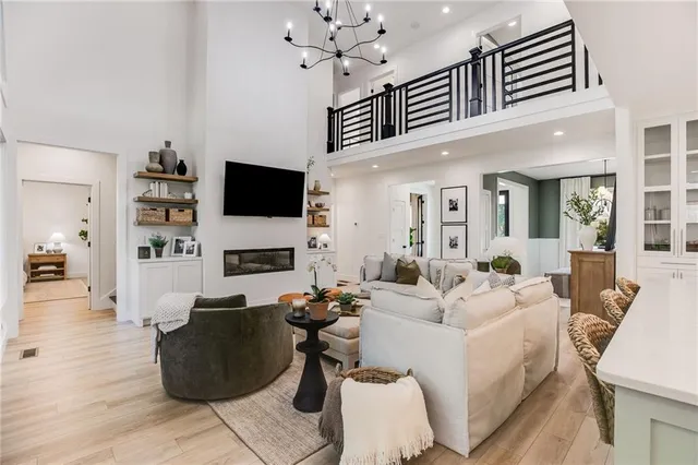 a spacious bedroom with a bed and a chandelier