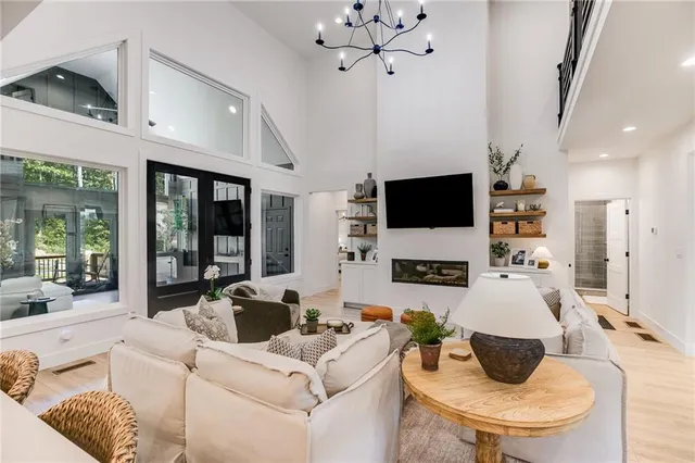 a spacious bedroom with a bed and a flat screen tv