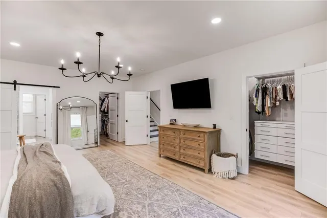 a spacious bedroom with a bed and a large window