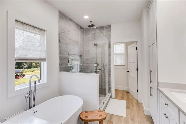 a spacious bedroom with a bed and a flat screen tv