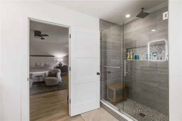 a view of a swimming pool with a bench and trees around