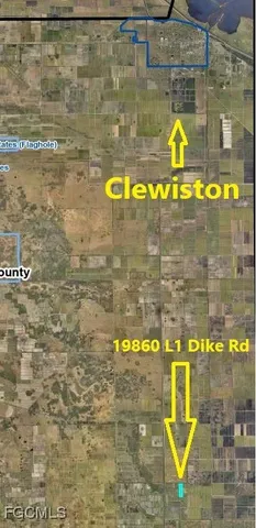 a kitchen view with wooden floor and windows