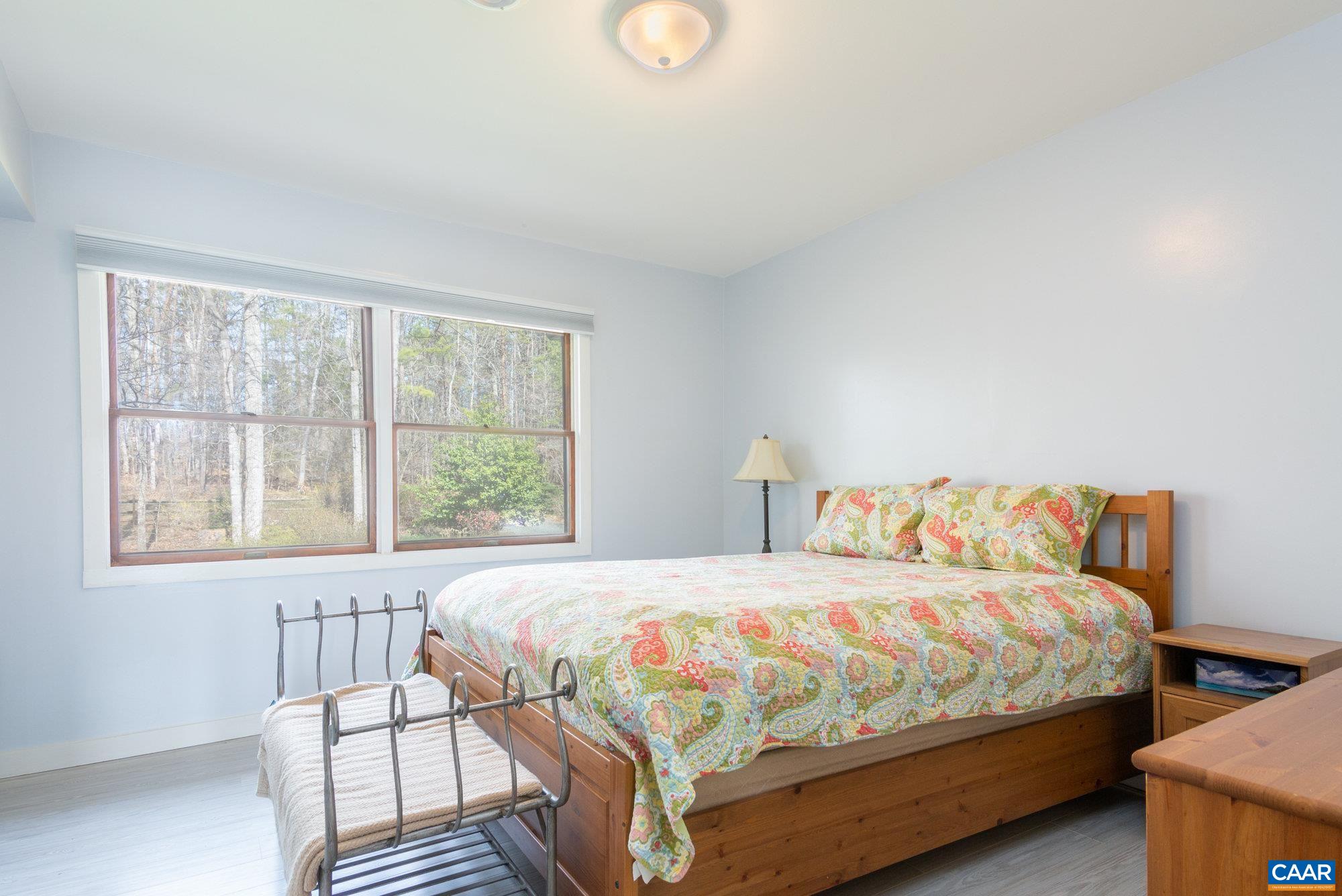 39 Tanglewood Road Palmyra, VA 22963 - Photo 11 of 33 a bedroom with a bed and wooden floor