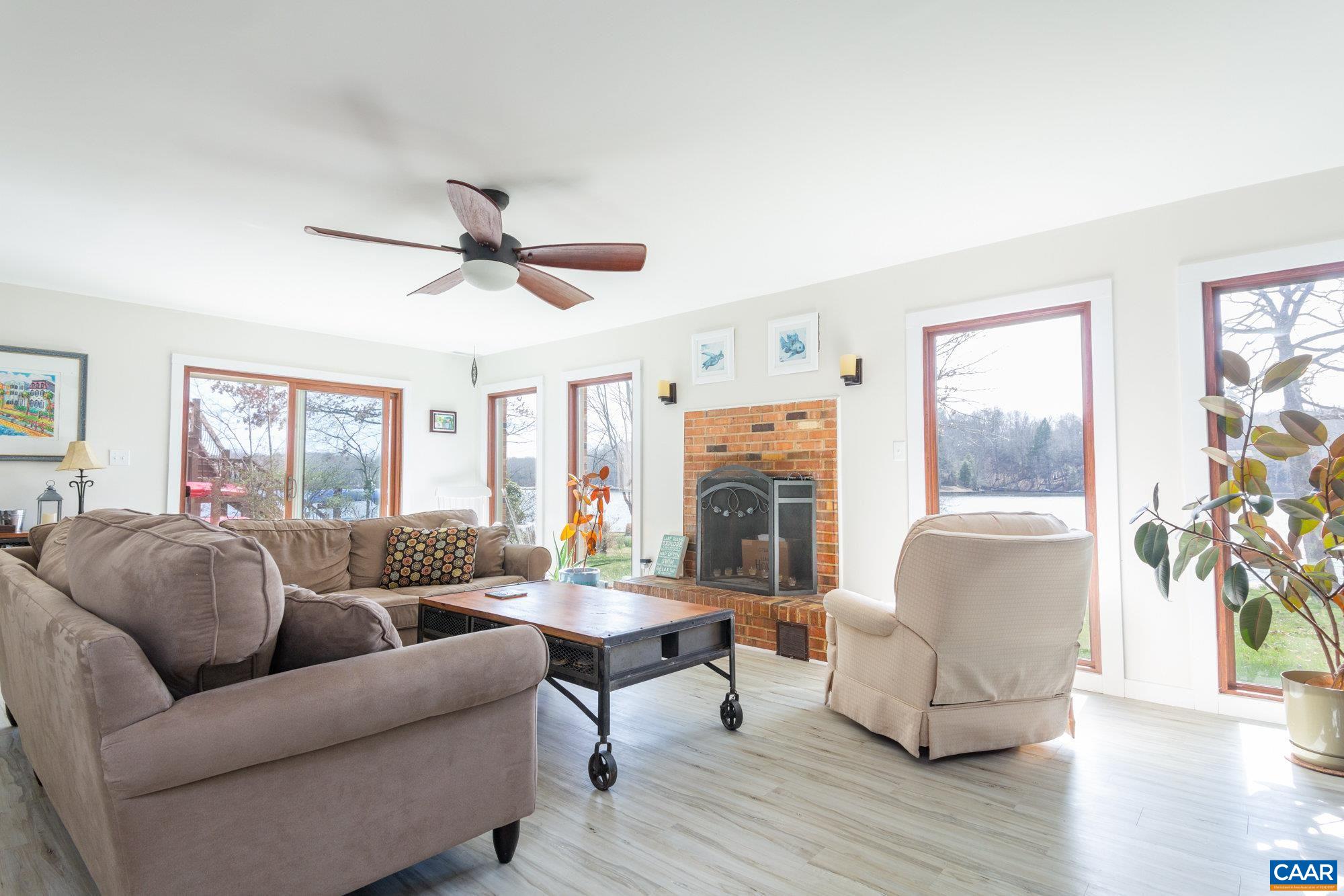 39 Tanglewood Road Palmyra, VA 22963 - Photo 17 of 33 a living room with furniture a fireplace and a large window