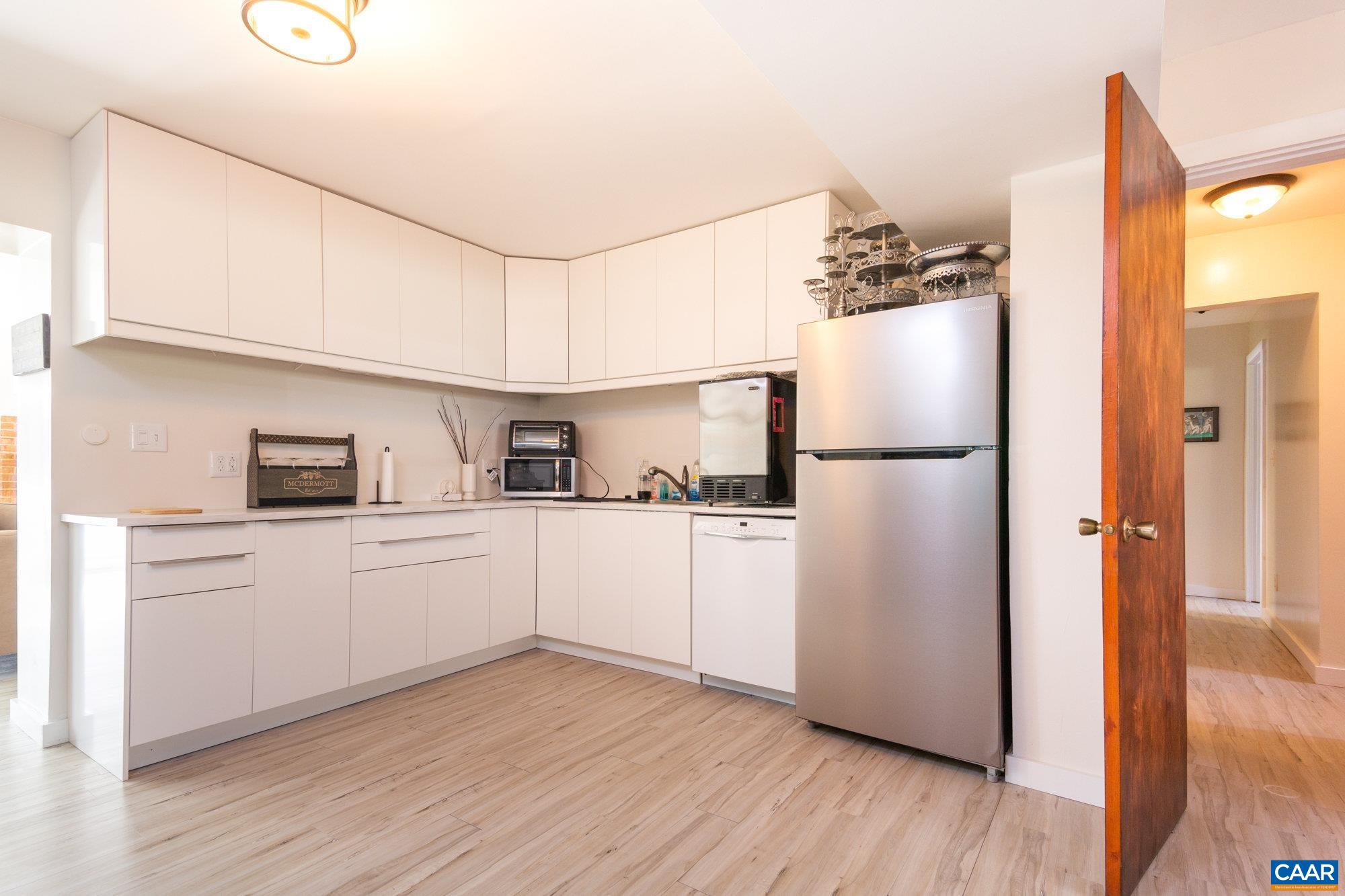 39 Tanglewood Road Palmyra, VA 22963 - Photo 19 of 33 a kitchen with a refrigerator and white cabinets