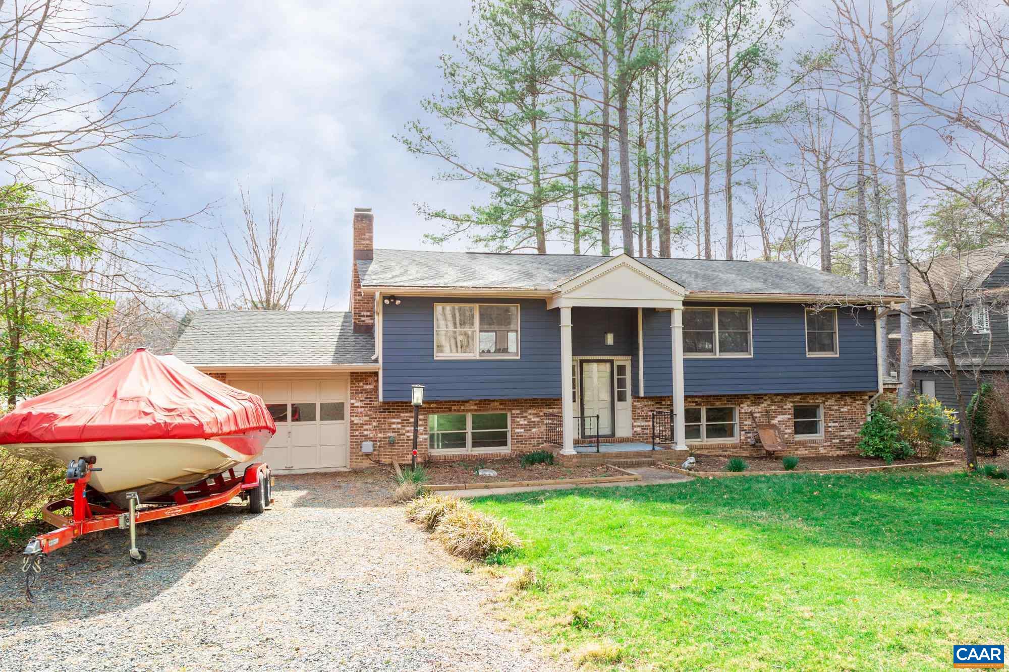 39 Tanglewood Road Palmyra, VA 22963 - Photo 2 of 33 a front view of a house with a yard table and chairs