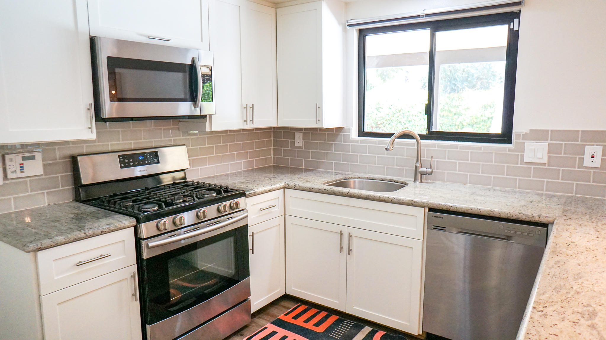 70355 Cobb Road Rancho Mirage, CA 92270 - Photo 10 of 27 a kitchen with granite countertop a stove a sink and a microwave