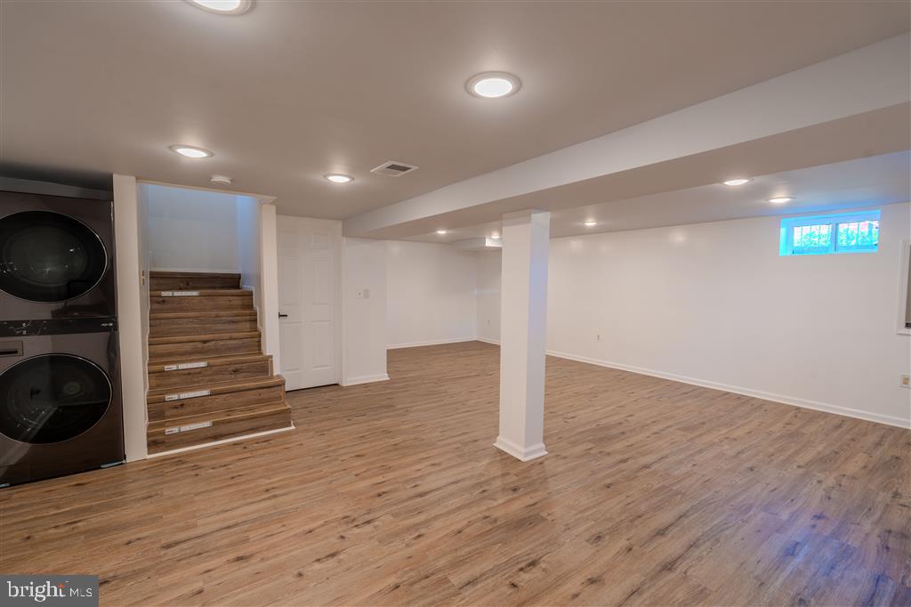 12324 Centerhill Street Silver Spring, MD 20902 - Photo 18 of 24 a view of a hallway with wooden floor and a fireplace