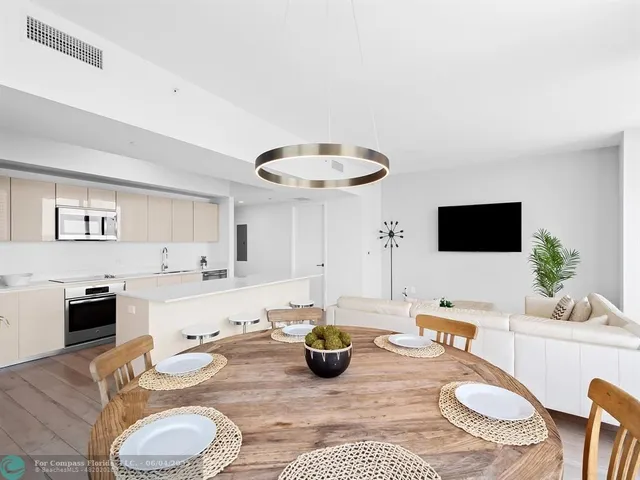 a kitchen with a sink a table and chairs