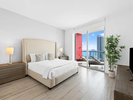 a bedroom with a bed and a potted plant