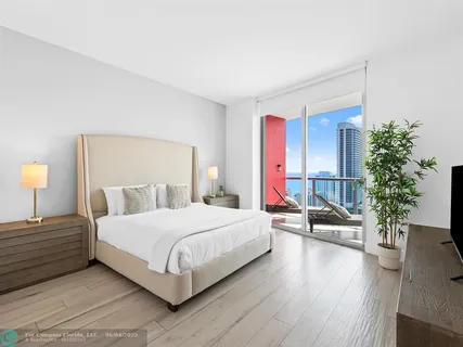 a bedroom with a bed and a potted plant