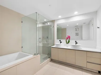 a bathroom with a tub sink and mirror