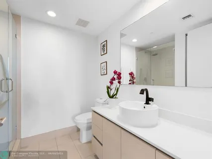 a bathroom with a sink vanity and a toilet