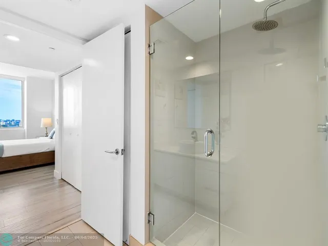 a bathroom with a shower and a tub