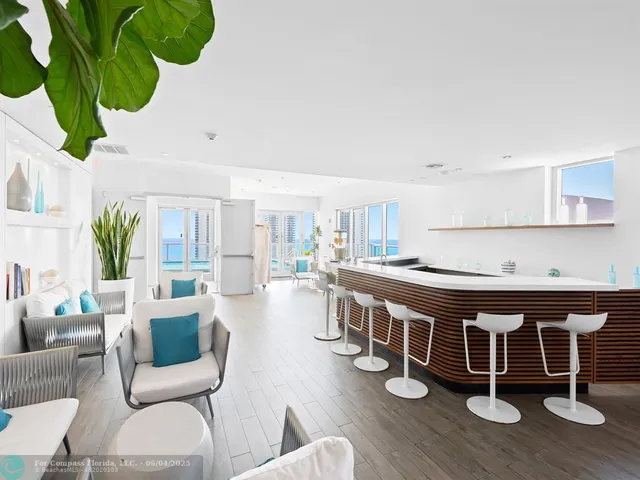 a large white kitchen with a large window