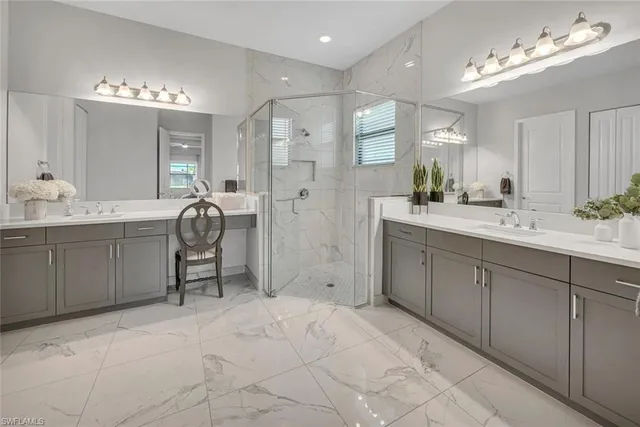 a spacious bathroom with a granite countertop sink a toilet a mirror and shower